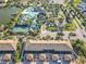 Aerial view of the community showcasing the pool, tennis court, lake, and surrounding residential area at 2054 Rome Dr, Kissimmee, FL 34747