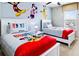 bedroom featuring two twin beds with colorful Disney themed bedding and decor at 2054 Rome Dr, Kissimmee, FL 34747