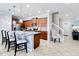 Kitchen view with stainless steel appliances, wooden cabinets, kitchen island, and staircase to the upper floor at 2054 Rome Dr, Kissimmee, FL 34747