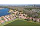 Stunning aerial view of lakeside homes featuring terra cotta roofs and screened-in pools at 5450 Watervista Dr, Orlando, FL 32821