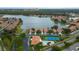 Community aerial view of the lake, houses, clubhouse, tennis court, and pool at 5450 Watervista Dr, Orlando, FL 32821