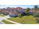 Exterior of a well-maintained house with lush lawn and mature palm trees at 5450 Watervista Dr, Orlando, FL 32821
