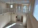 Spacious foyer featuring tile flooring, staircase, and an open view into the living area with abundant natural light at 5450 Watervista Dr, Orlando, FL 32821