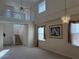 Open living room with soaring ceilings, natural light, and a staircase to the second floor at 5450 Watervista Dr, Orlando, FL 32821