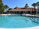 Community pool with clear blue water and plenty of lounge seating at 5450 Watervista Dr, Orlando, FL 32821