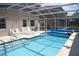Large screened pool with clear blue water, lounge chairs and access to the house at 5450 Watervista Dr, Orlando, FL 32821