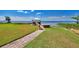 Peaceful backyard featuring a dock with a gazebo and stunning lake views at 2205 Cypress Cove Dr, Tavares, FL 32778