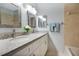 Bathroom featuring granite double vanity, modern lighting, and tile flooring create a spa-like experience at 2205 Cypress Cove Dr, Tavares, FL 32778