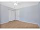 Cozy bedroom featuring wood flooring, a ceiling fan and a closet at 2205 Cypress Cove Dr, Tavares, FL 32778