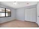 Well-lit bedroom featuring wood flooring, a ceiling fan and a closet at 2205 Cypress Cove Dr, Tavares, FL 32778