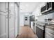 Updated kitchen with stainless steel appliances, white cabinets, and modern hardware at 2205 Cypress Cove Dr, Tavares, FL 32778