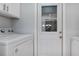 Well-equipped laundry room features modern appliances and a convenient access door to the exterior of the house at 2205 Cypress Cove Dr, Tavares, FL 32778