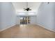 Bright living room with vaulted ceiling, wood floors, fan and sliding glass doors at 2205 Cypress Cove Dr, Tavares, FL 32778