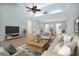 Spacious, open-concept living room with vaulted ceilings, modern furniture, and lots of natural light at 2205 Cypress Cove Dr, Tavares, FL 32778