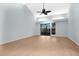 Bright living room featuring sliding glass doors and a vaulted ceiling at 2205 Cypress Cove Dr, Tavares, FL 32778