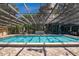 Enclosed pool area with mature landscaping and plenty of space for dining at 2205 Cypress Cove Dr, Tavares, FL 32778