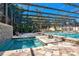 Inviting pool and spa area with a screened enclosure for year-round enjoyment at 2205 Cypress Cove Dr, Tavares, FL 32778