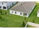 Aerial view of a home with a well-manicured lawn, patio, and fenced backyard at 4054 Serene Water Ave, Eustis, FL 32736