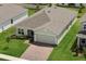 Aerial view of single-story home, featuring lush green lawn, brick driveway, and a well-maintained neighborhood at 4054 Serene Water Ave, Eustis, FL 32736