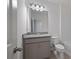 Well-lit bathroom with gray vanity, granite countertop, undermount sink, and tile flooring at 4054 Serene Water Ave, Eustis, FL 32736
