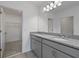 Bright bathroom featuring double vanity, granite countertops, and a walk-in closet at 4054 Serene Water Ave, Eustis, FL 32736
