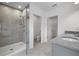 Modern bathroom featuring walk-in shower with glass door, gray tile and granite countertops at 4054 Serene Water Ave, Eustis, FL 32736