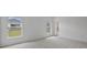 Bright bedroom with carpet flooring, two windows with blinds, and a view of the outside at 4054 Serene Water Ave, Eustis, FL 32736