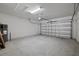 Spacious garage with concrete flooring, white brick walls, and an automatic garage door at 4054 Serene Water Ave, Eustis, FL 32736