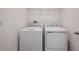 Functional laundry room with white washer and dryer, wire shelving, and convenient electrical outlets at 4054 Serene Water Ave, Eustis, FL 32736