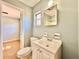 Bright bathroom featuring a modern vanity, mirror and fixtures, along with tile flooring at 544 S Cottage Hill Rd, Orlando, FL 32805
