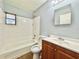 Traditional bathroom with a bathtub and shower, wooden vanity and large mirror to get ready at 544 S Cottage Hill Rd, Orlando, FL 32805