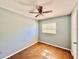 This is a bedroom featuring tile floors, a ceiling fan, and a window at 544 S Cottage Hill Rd, Orlando, FL 32805