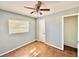 A sunlit bedroom featuring tile floors, a ceiling fan, a door and a window at 544 S Cottage Hill Rd, Orlando, FL 32805