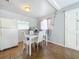 Cozy dining area with a white table, chairs, and ample natural light from the window at 544 S Cottage Hill Rd, Orlando, FL 32805