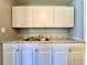 Kitchen with ample counter space with stainless sink and overhead cabinets at 544 S Cottage Hill Rd, Orlando, FL 32805