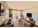 Bright living room featuring stylish furnishings, large windows, and a neutral color palette at 544 S Cottage Hill Rd, Orlando, FL 32805