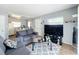 Comfortable living room with a large TV, gray sofas, and sliding glass doors for natural light at 544 S Cottage Hill Rd, Orlando, FL 32805