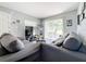 Comfortable living room with a large gray sectional, TV, sliding glass door, and neutral decor at 544 S Cottage Hill Rd, Orlando, FL 32805