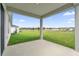 Covered back patio looking out onto a big lawn at 2633 Hancock Crossing Dr, Bartow, FL 33830