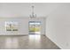 Bright living room with tile flooring, a chandelier, and sliding glass doors to the outdoors at 2633 Hancock Crossing Dr, Bartow, FL 33830