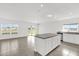 Open concept living room and kitchen with tile floors and a center island, filled with natural light at 2633 Hancock Crossing Dr, Bartow, FL 33830