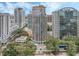Expansive city view of a modern building, surrounded by lush trees and bustling city streets at 322 E Central Blvd # 401, Orlando, FL 32801
