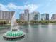 Scenic view of the lake featuring a fountain, surrounded by lush trees and stunning cityscape skyline at 322 E Central Blvd # 401, Orlando, FL 32801