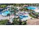 Large community pool with water features and palm trees at 8831 Interlocking Ct, Davenport, FL 33896