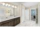 Double vanity bathroom with dark brown cabinets at 8831 Interlocking Ct, Davenport, FL 33896