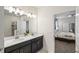 Double vanity bathroom with a large mirror and a walk-in shower at 8831 Interlocking Ct, Davenport, FL 33896