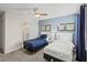 Two twin beds, ceiling fan, and en-suite bathroom access at 8831 Interlocking Ct, Davenport, FL 33896