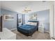 King-size bed, ceiling fan, and window with view at 8831 Interlocking Ct, Davenport, FL 33896