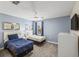 Bright bedroom with two twin beds, nightstands, and ceiling fan at 8831 Interlocking Ct, Davenport, FL 33896