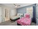 Two twin beds, ceiling fan, and en-suite bathroom at 8831 Interlocking Ct, Davenport, FL 33896